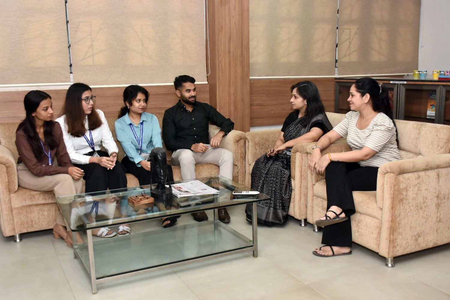 VESIM students and faculty interacting in a library room